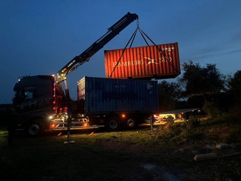 used 20ft container being unloaded by truck-mounted crane